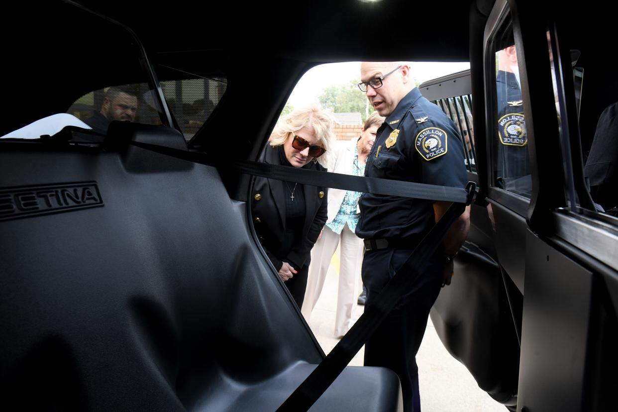 Massillon Police Chief Jason Saintenoy, right, shows Mayor Kathy Catazaro-Perry some features inside one of the agency's new 2023 Dodge Durangos. Overall, the Police Department has 19 vehicles in its fleet, five of which are undercover cars.