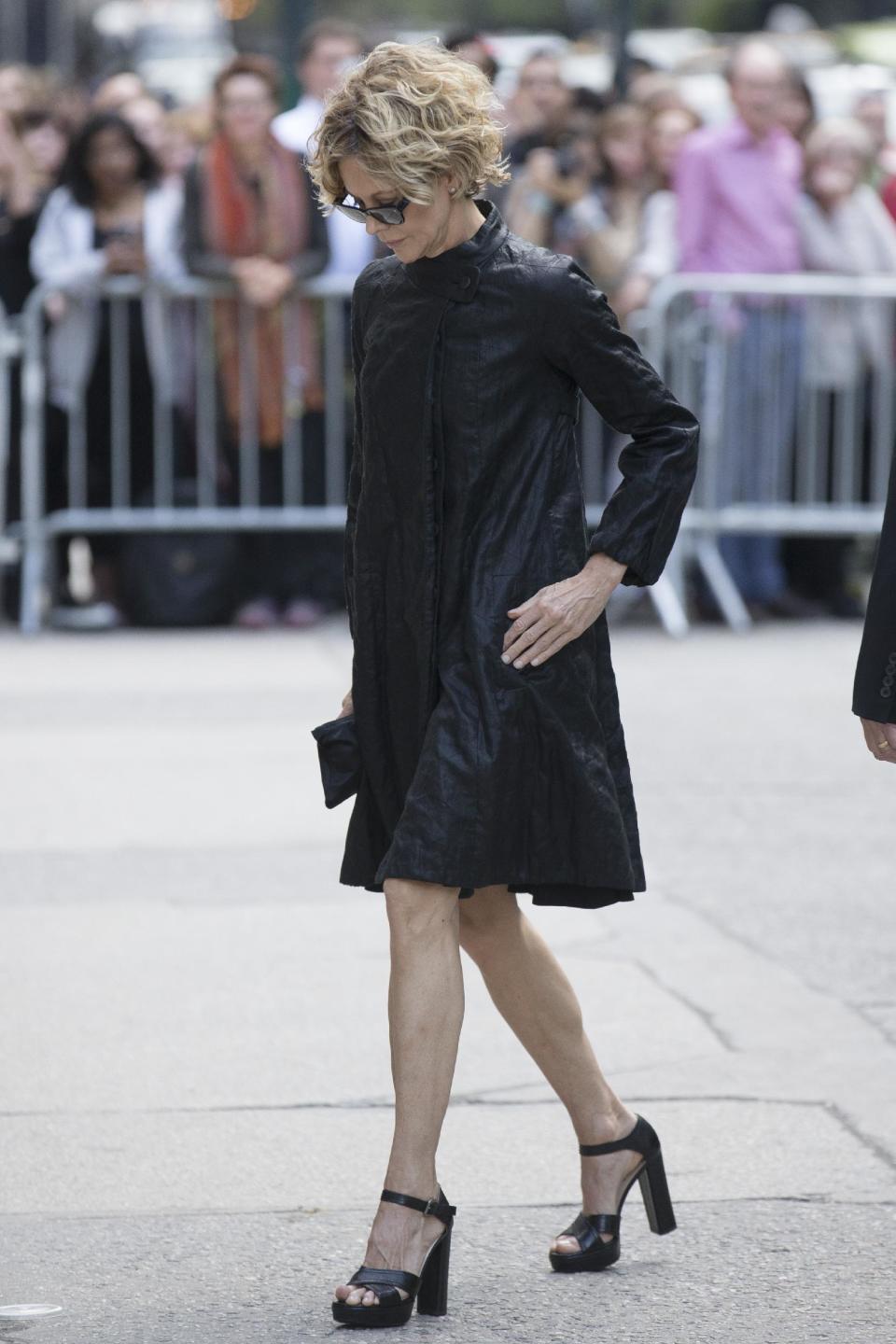 Actress Meg Ryan arrives at St. Bartholomew's Church for a memorial service for fashion designer L'Wren Scott, Friday, May 2, 2014, in New York. Scott committed suicide on March 17 in her Manhattan apartment. (AP Photo/John Minchillo)