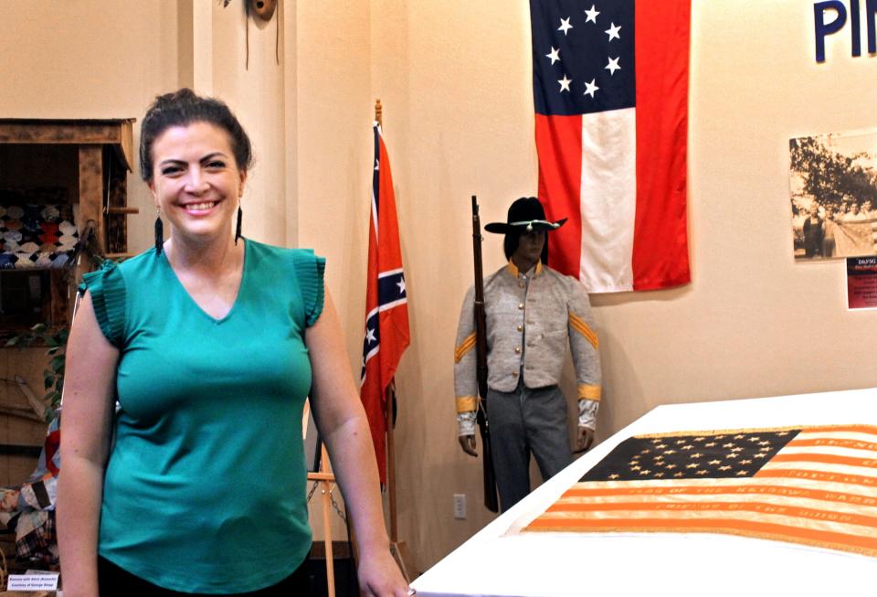 Victoria Holland poses for a photo at the United Keetoowah Band museum located at its headquarters. She is the tribe's chosen delegate as it tries to assert rights under the Treaty of New Echota. As an attorney, she also helps her tribe navigate other legal issues.
