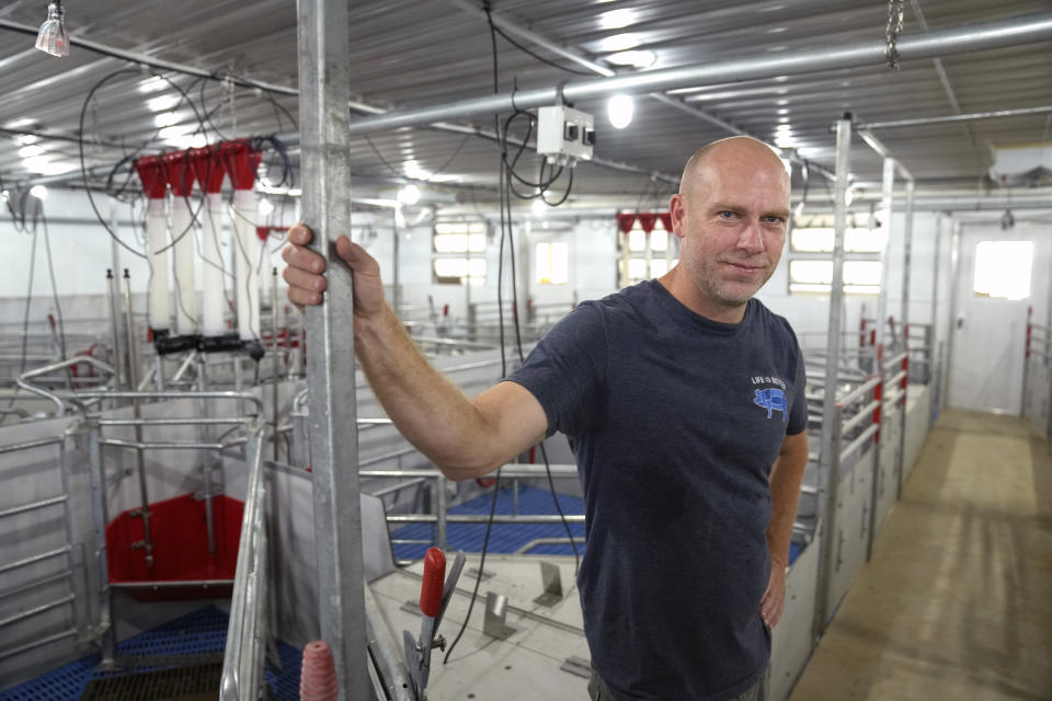 Jared Schilling poses for a photo inside a newly constructed farrowing room on his sow farm Thursday, June 29, 2023, in Walsh, Ill. Schilling has made his farm compliant with a California law, taking effect on July 1, requiring that any fresh pork sold in the state be born to sows that were given at least 24 square feet of space, allowing them to turn around and extend their limbs. (AP Photo/Jeff Roberson)