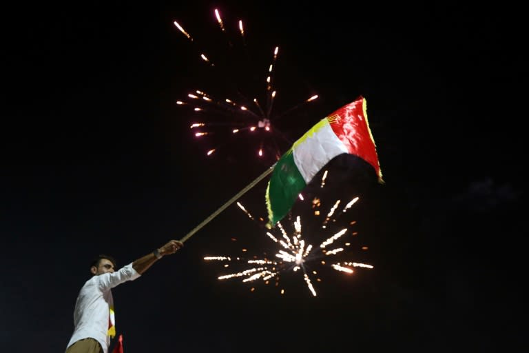 Iraqi Kurds wave the Kurdish flag as they celebrate in the streets of the northern city of Arbil on September 25, 2017 following a referendum on independence