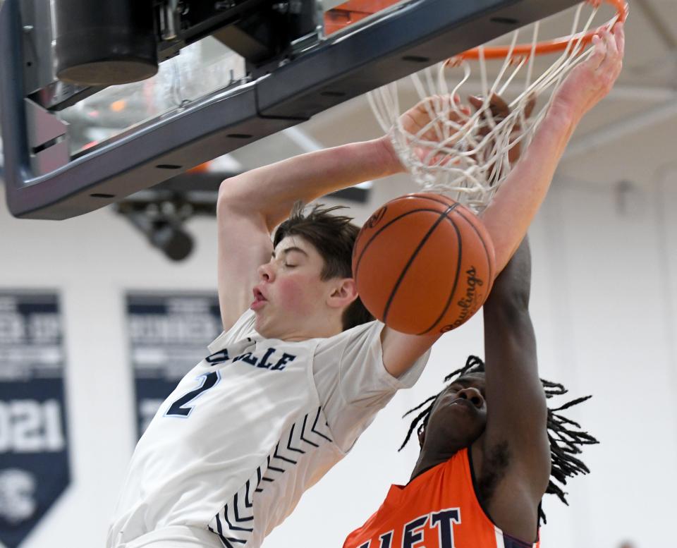 Louisville's Brayden Gross (left) throws down a dunk against Ellet during a boys high school basketball game at Louisville on Saturday, January 21, 2023.