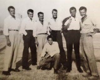 The Huth brothers line up for a 1940s portrait in Akron. Pictured from left to right are Richard (“Dick”), Albert (“Al”), Gilbert (“Gib”), Henry (“Hank”), Gene (“Buster”), Theodore (“Bud”) and, kneeling, Daniel (“Danny”).