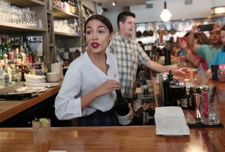 Rep. Alexandria Ocasio-Cortez (D-NY) serves drinks in support of One Fair Wage at The Queensboro restaurant in the Queens borough of New York