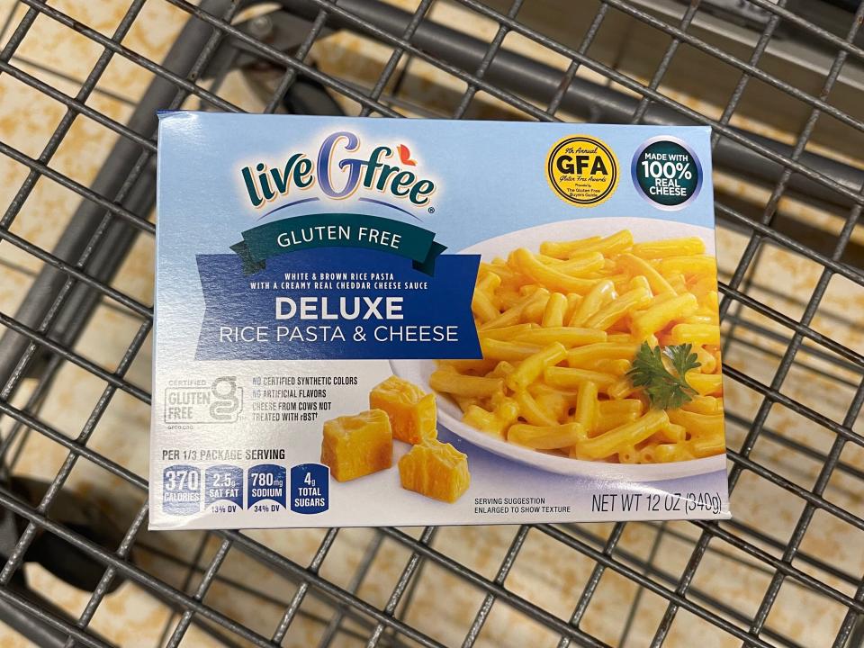 A box of liveGfree gluten-free deluxe rice-pasta and cheese in a shopping cart.