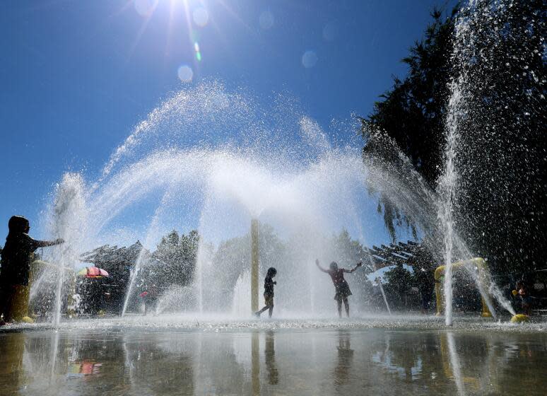 Fullerton, CA - August 04: Kids cool off amid the heat on a summer day at the Lemon Park Spray Pool in Fullerton Friday, Aug. 4, 2023. (Allen J. Schaben / Los Angeles Times)