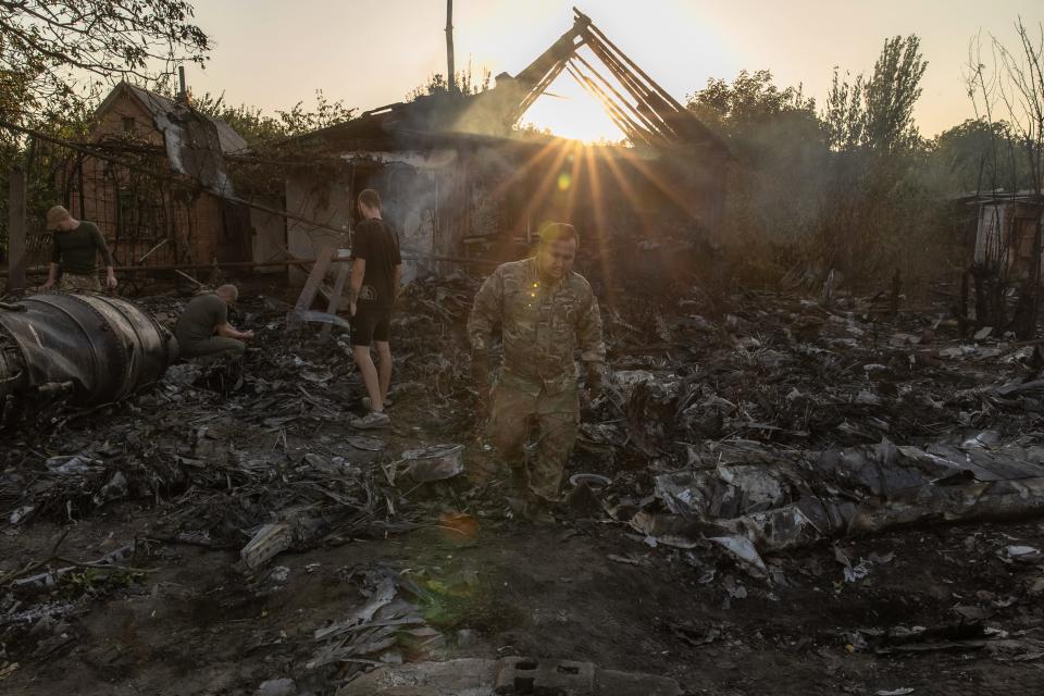 Ukrainian scene investigators examine the wreckage the S-70 in eastern Ukraine on October 5.