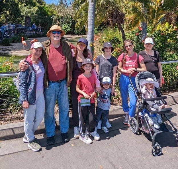 Standing on U.S. soil in San Diego, the Ukrainian families include, from left, Masha, their sponsor Grant Ceffalo, Tania, Ksyusha, Artem, Mira, Olya, Nikol, and Tamara.