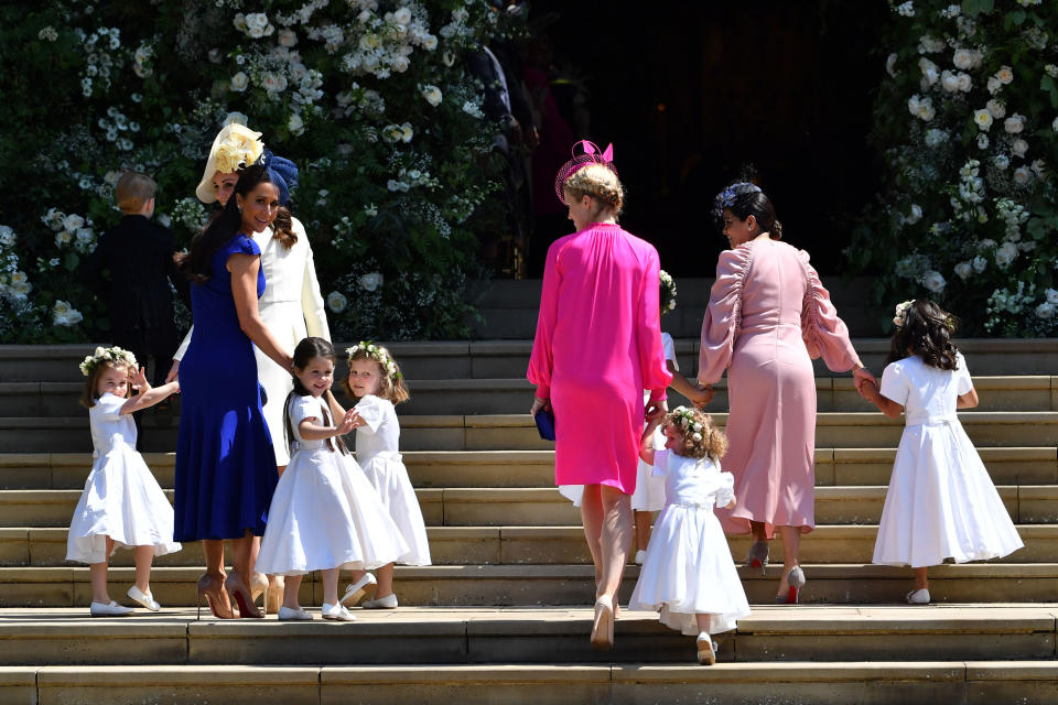 The Duchess of Cambridge and Meghan Markle's friend, Canadian fashion stylist Jessica Mulroney (second left) holds bridesmaids hands as they arrive for the wedding ceremony of Prince Harry to Meghan Markle at St. George's Chapel in Windsor Castle. (Photo by Ben Stansall/PA Images via Getty Images)