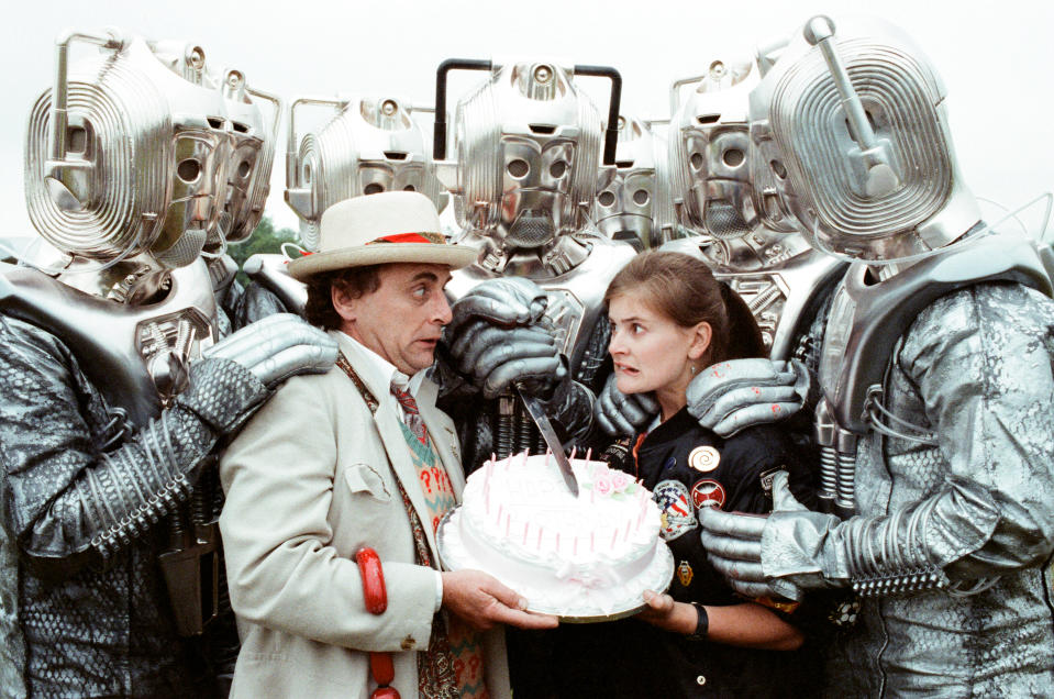 Sylvester McCoy as the Doctor and Sophie Aldred as Ace seen here on location near Arundel with the Cybermen during the filming of the Dr Who story called The Silver Nemesis, 28th June 1988. (Photo by Arthur Sidey/Mirrorpix/Getty Images)