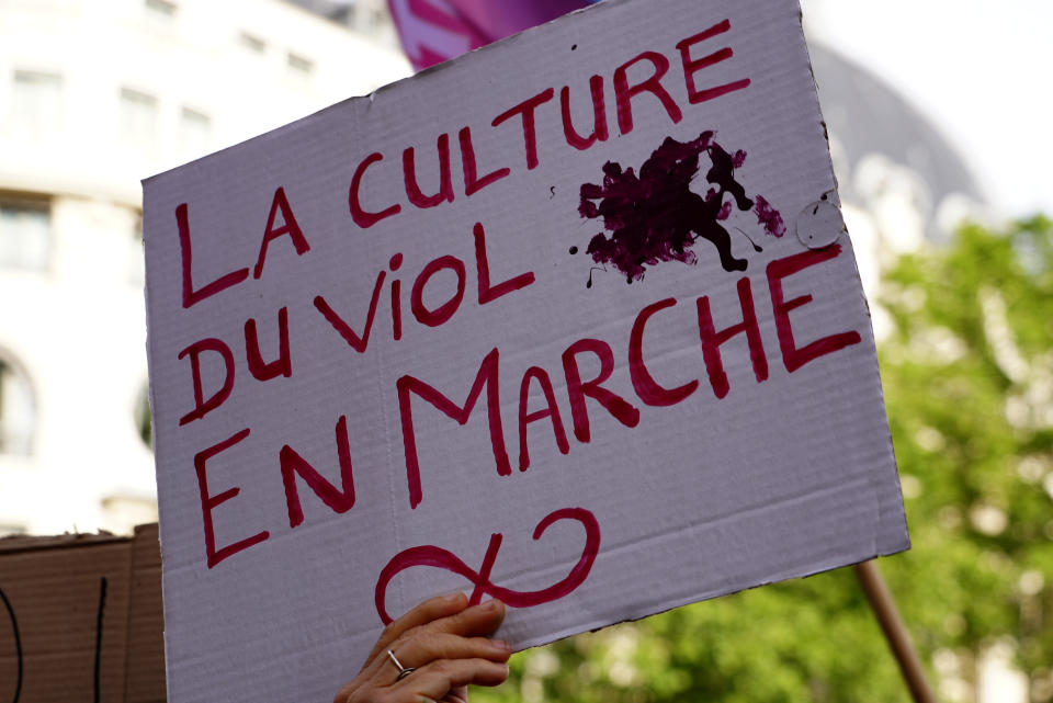 A woman shows a poster reading "Rape culture on its way" , referring to French President Emmanuel Macron's party, during a demonstration organized by a feminist association called the Observatory on Sexual and Gender-based violence in politics, Tuesday, May 24, 2022 in Paris. Rape accusations against a newly named French government minister have galvanized a movement aimed at exposing sexual misconduct in French politics and encouraging women to speak out against abusers. (AP Photo/Nicolas Garriga)