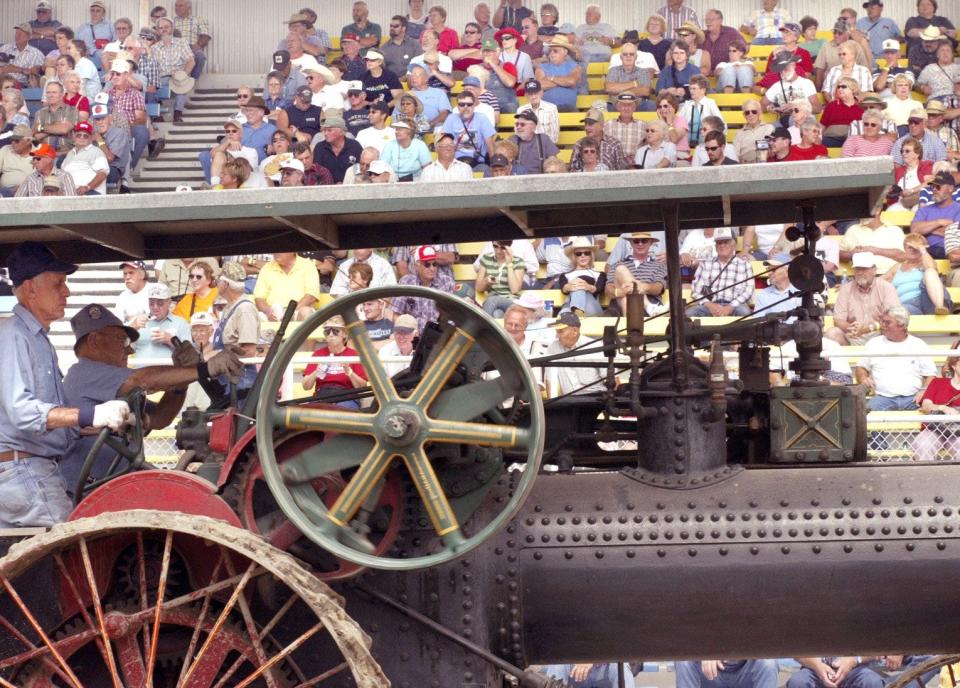 A steam powered tractor passes in front of the grand stands at the Old Threshers Reunion in Mount Pleasant.