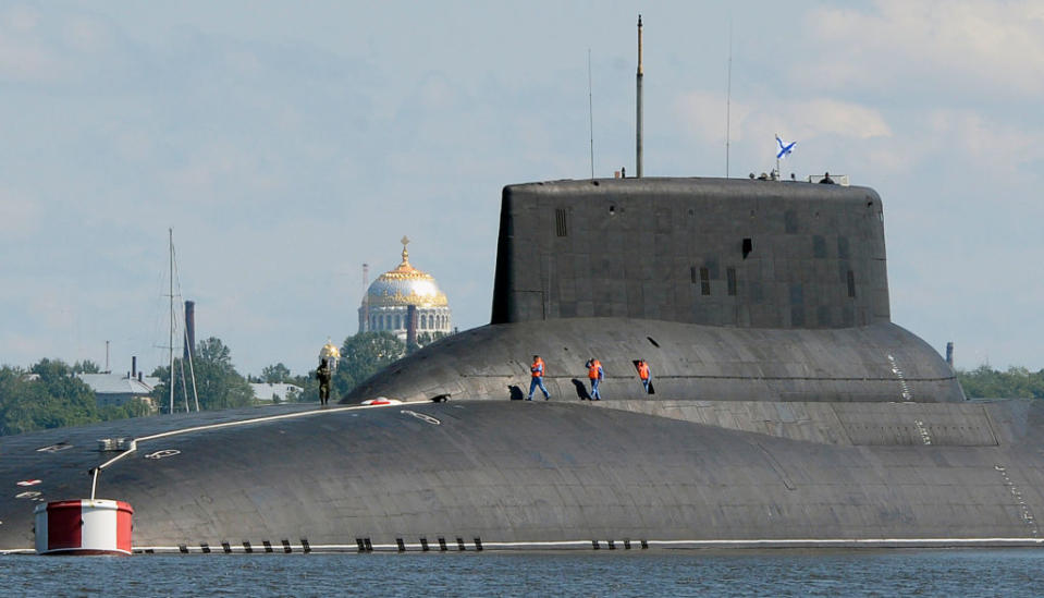 The photo is from very far away, and yet the submarine takes up the whole frame; the people walking on board look like ants