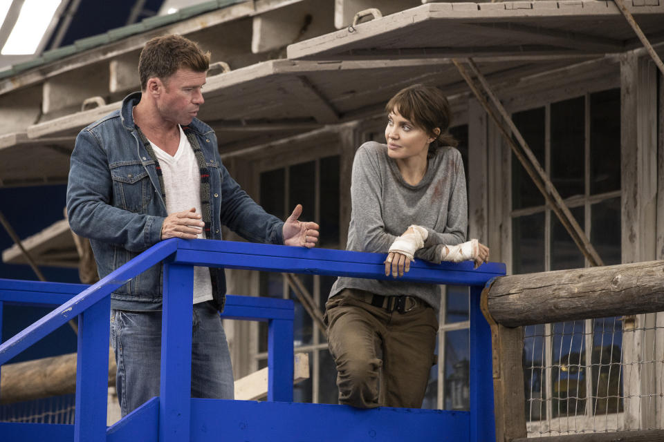 This image released by Warner Bros. Entertainment shows director Taylor Sheridan, left, with Angelina Jolie on the set of "Those Who Wish Me Dead." (Emerson Miller/Warner Bros. Entertainment via AP)