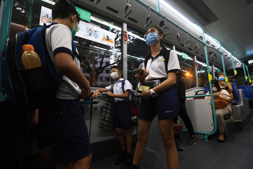 Students wearing protective masks commuting to school pay higher bus fares in Singapore in 2023