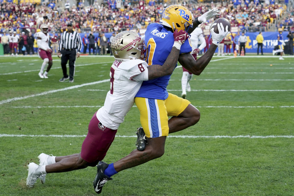 Pittsburgh wide receiver Bub Means (0) pulls in a pass for a touchdown as he is defended by Florida State defensive back Renardo Green (8) during the first half of an NCAA college football game in Pittsburgh, Saturday, Nov. 4, 2023. (AP Photo/Matt Freed)