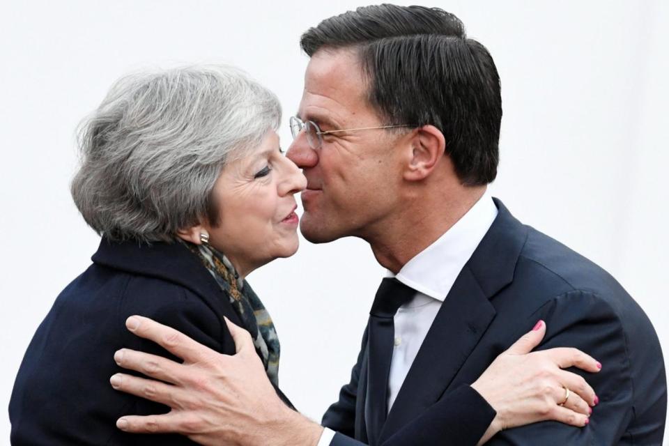 Warm welcome: Theresa May is greeted by Dutch prime minister Mark Rutte ahead of talks in The Hague (REUTERS)