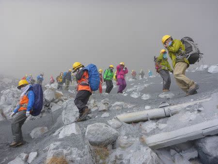 Climbers descend Mt. Ontake, which straddles Nagano and Gifu prefectures, to evacuate as volcanic ash falls at the mountain in central Japan September 27, 2014, in this photo taken by a climber and released by Kyodo. REUTERS/Kyodo