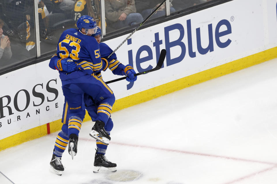 Buffalo Sabres left wing Jeff Skinner (53) leaps into Dylan Cozens arms after Cozens score the game-tying goal late in the third period of an NHL hockey game against the Boston Bruins, Saturday, Dec. 31, 2022, in Boston. (AP Photo/Mary Schwalm)