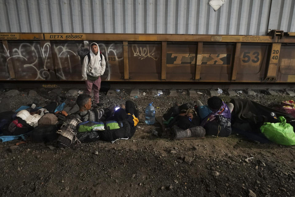 Migrants wait to hop a northbound freight train in Irapuato, Mexico, Saturday, Sept. 23, 2023. (AP Photo/Marco Ugarte)