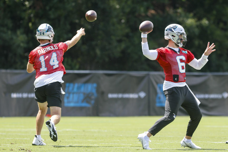 Carolina Panthers quarterbacks Sam Darnold, left, and Baker Mayfield throw at the NFL football team's training camp at Wofford College in Spartanburg, S.C., Wednesday, July 27, 2022. (AP Photo/Nell Redmond)