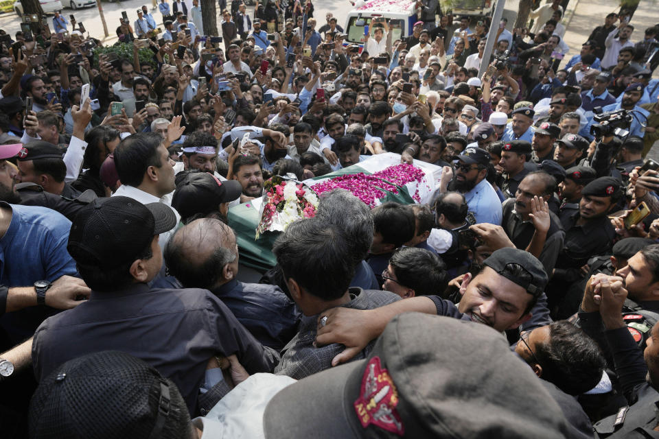 People carry the casket of slain senior Pakistani journalist Arshad Sharif for funeral prayer, in Islamabad, Pakistan, Thursday, Oct. 27, 2022. Thousands of mourners in the capital, Islamabad on Thursday attended the funeral of the outspoken Pakistani journalist who was shot and killed by Nairobi police, as the spy chief and the military spokesman paid tributes to him because of his journalistic work and demanded a probe into his killing. (AP Photo/Anjum Naveed)