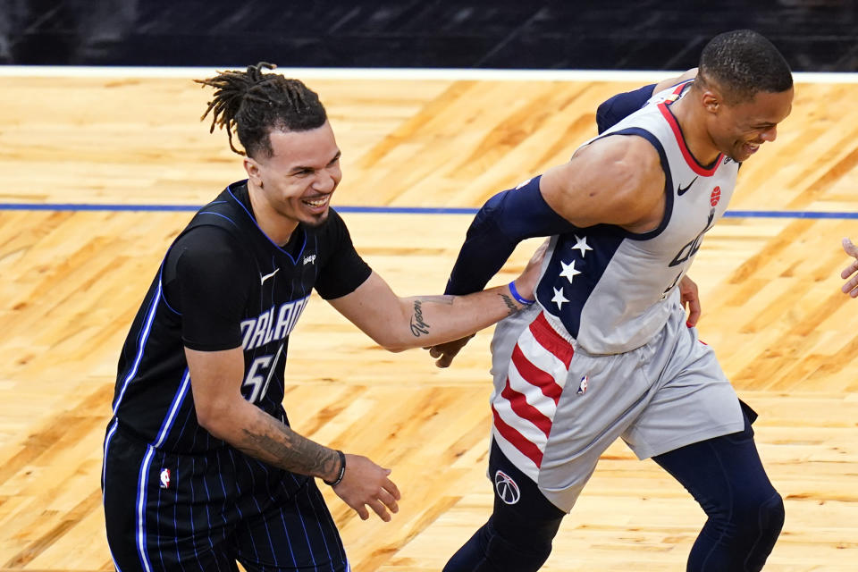 Orlando Magic guard Cole Anthony, left, jokes with Washington Wizards guard Russell Westbrook after Anthony was called for goaltending on a Westbrook shot during the second half of an NBA basketball game Wednesday, April 7, 2021, in Orlando, Fla. (AP Photo/John Raoux)