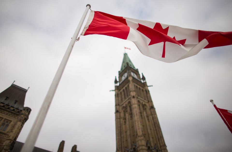 A Canadian flag flies in front of the peace tower on Parliament Hill in Ottawa, Canada on December 4, 2015, as part of the ceremonies to the start Canada's 42nd parliament .   AFP PHOTO/GEOFF ROBINS (Photo by GEOFF ROBINS / AFP) (Photo by GEOFF ROBINS/AFP via Getty Images)