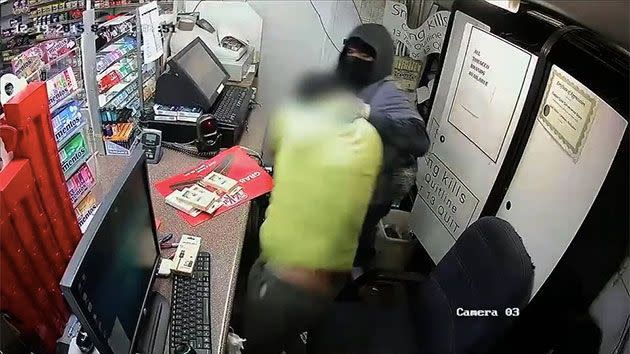 The two struggle with each other inside the cage before the robber stabs the attendant and flees the scene. Photo: NSW Police