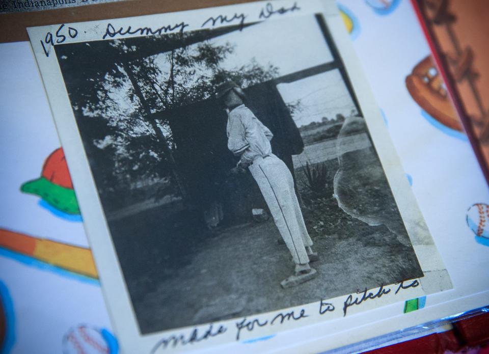 A photo from the 1950s of a dummy in the backyard of Patty Tatum McDonald's childhood home sits inside a softball scrapbook on McDonald's kitchen table Tuesday, March 8, 2022. "I'd pitch to it instead of someone standing there all day long," McDonald said. "People'd go by and say, 'I saw you.' It wasn't me it was my dummy."