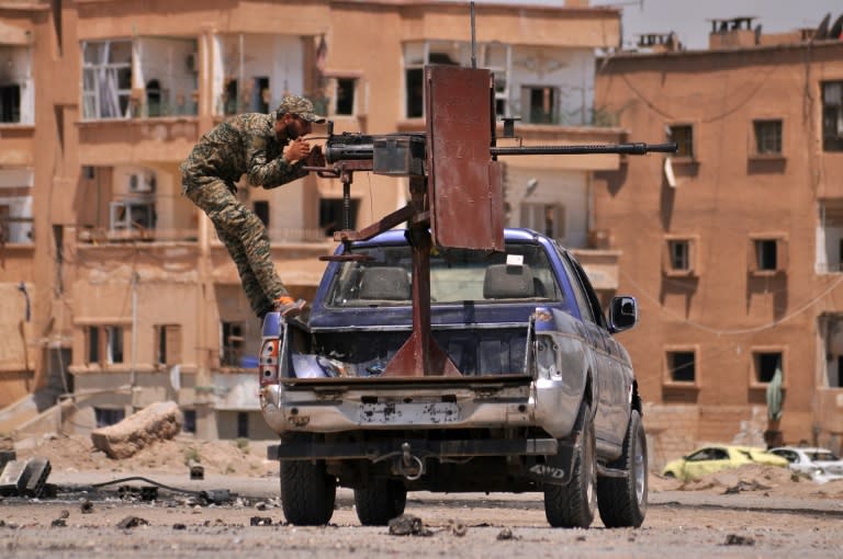A member of the Kurdish People's Protection Units (YPG) mans a mounted machine gun in the Al-Nashwa neighbourhood in the northeastern Syrian province of Hasakeh on July 26, 2015