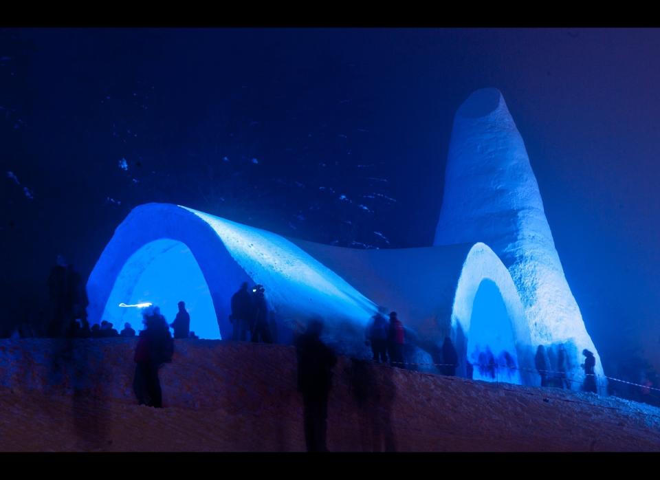 Visitors stand around a snow church just after its inauguration on Dec. 28, 2011 in Mitterfirmiansreut, Germany. The circa 25 meters long church was made of 1,400 cubic meters of snow and aims to commemorate the winter of the years 1910/1911, when so much snow fell that believers of Mitterfirmiansreut were no more able to go to church in the neighboring community of Mauth. So they decided to build their own church, made of snow. (Armin Weigel, AFP / Getty Images)