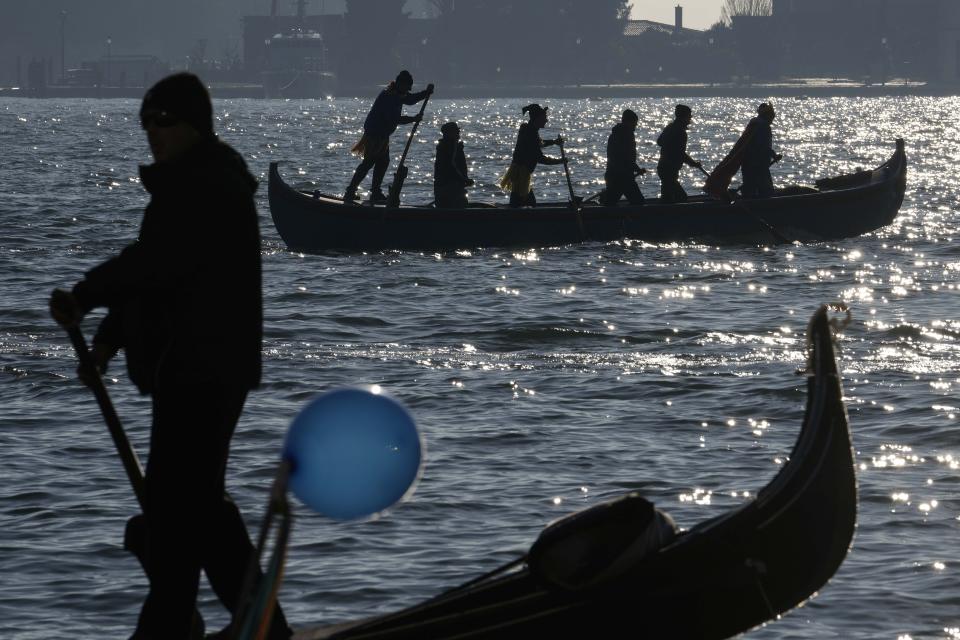 Boats sail during the traditional rowing parade, part of the Venice Carnival in Venice, Italy, Sunday Jan. 28, 2024. Venice is marking the 700th anniversary of the death of Marco Polo with a yearlong series of commemorations, starting with the opening of Carnival season honoring one of the lagoon city's most illustrious native sons. (AP Photo/Luca Bruno)