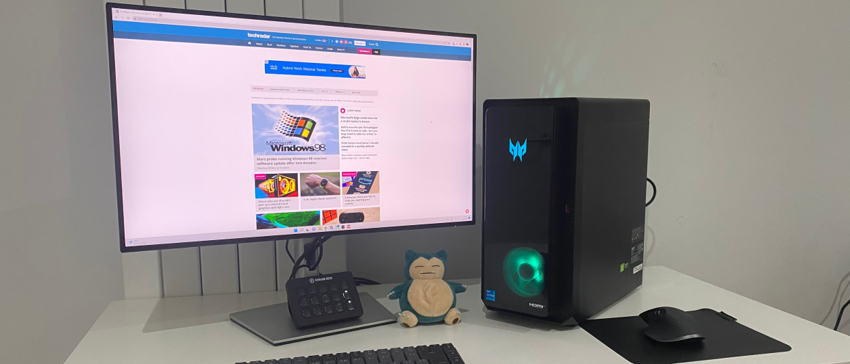  Acer Predator Orion 3000 desktop gaming PC on a desk with RGB lighting turned on. 
