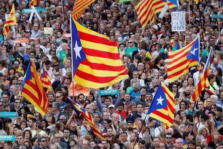 People wave Catalan separatist flags during a demonstration organised by Catalan pro-independence movements ANC (Catalan National Assembly) and Omnium Cutural, following the imprisonment of their two leaders Jordi Sanchez and Jordi Cuixart, in Barcelona, Spain, October 21, 2017. REUTERS/Gonzalo Fuentes