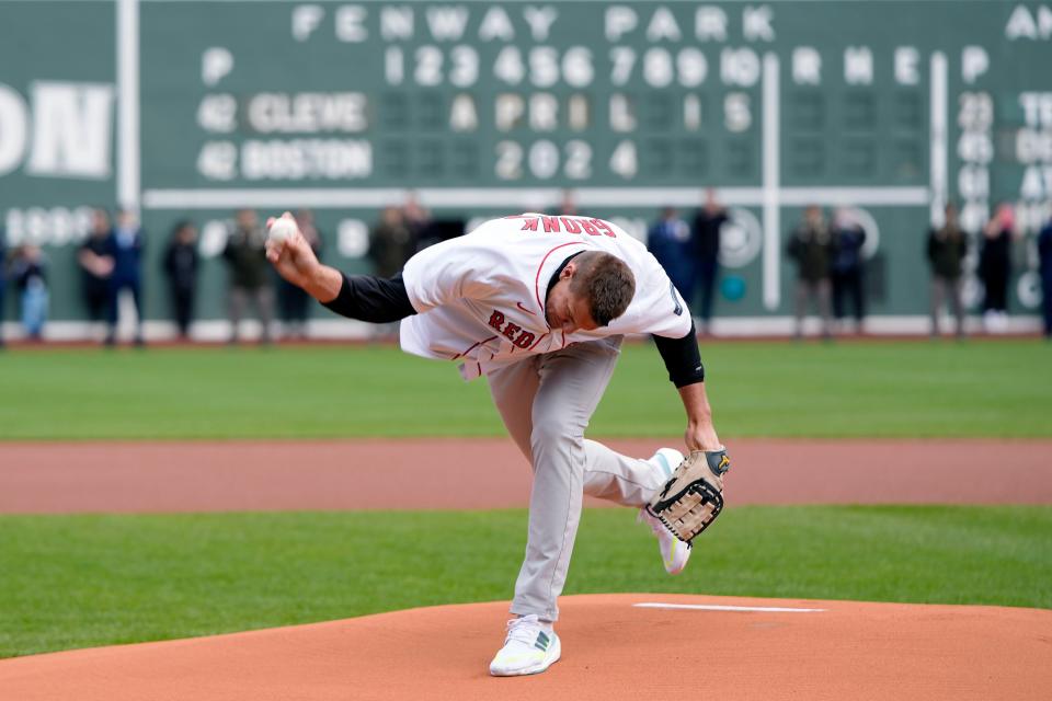 Former New England Patriots NFL football player Rob Gronkowski spikes the ball instead of throwing it during the ceremonial first pitch before a baseball game between the Boston Red Sox and the Cleveland Guardians, Monday, April 15, 2024, in Boston. (AP Photo/Michael Dwyer)