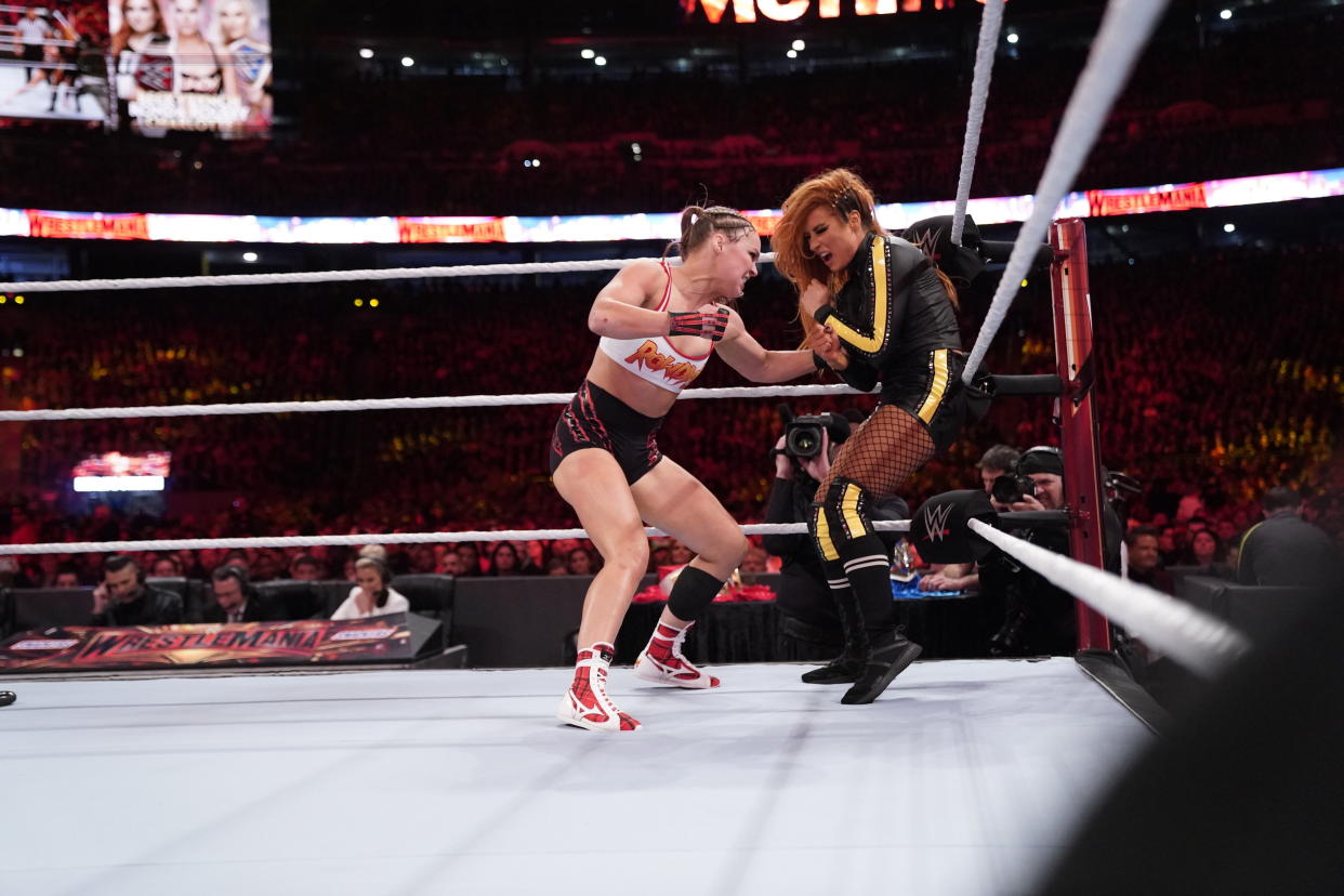 Ronda Rousey punches Becky Lynch during the main event of WrestleMania 35 at MetLife Stadium in East Rutherford, N.J. (WWE)