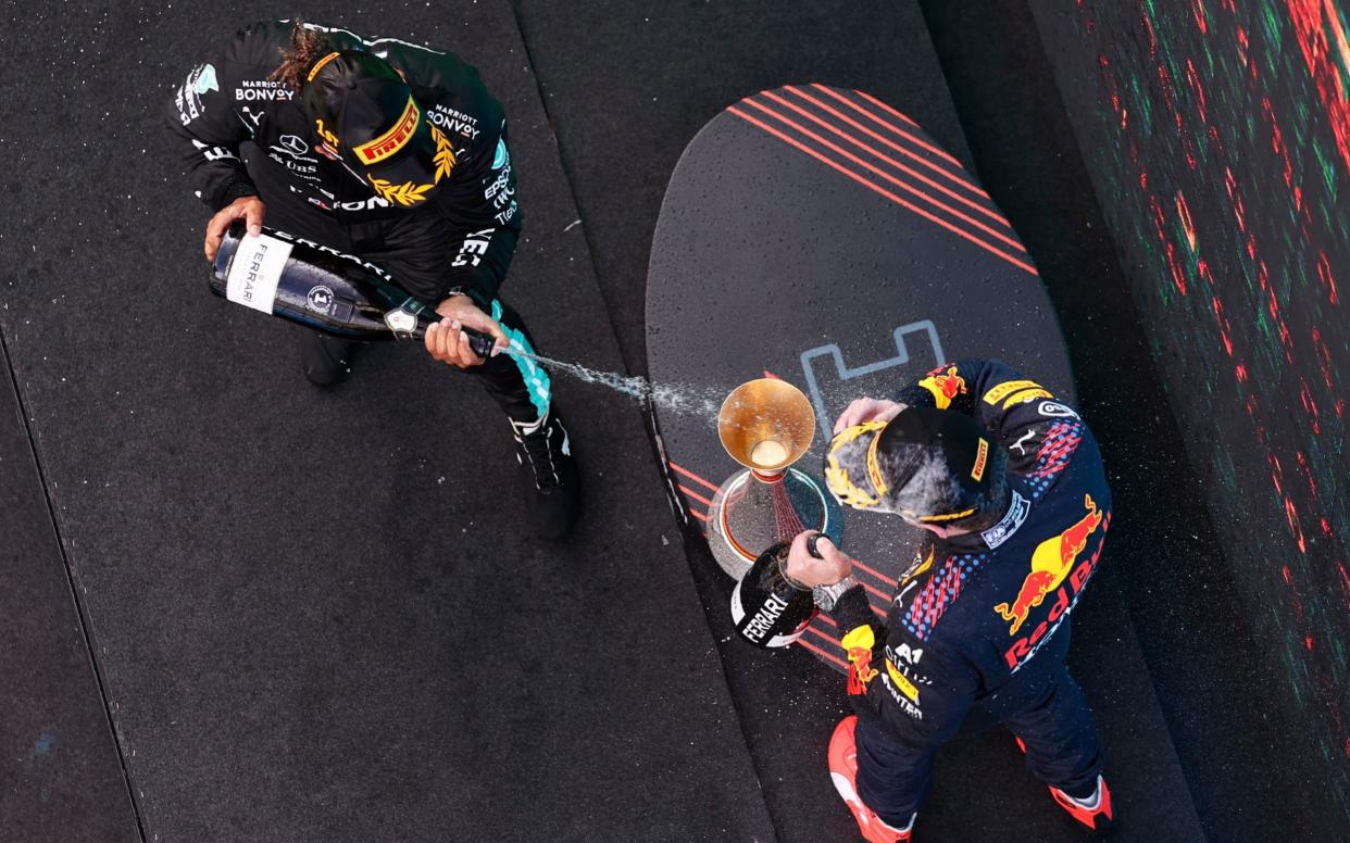 Winner Mercedes driver Lewis Hamilton of Britain sprays second placed Red Bull driver Max Verstappen of the Netherlands, right, on the podium of the Spanish Formula One Grand Prix at the Barcelona Catalunya racetrack in Montmelo, just outside Barcelona, Spain, Sunday, May 9, 2021 - Lars Baron/Pool via AP