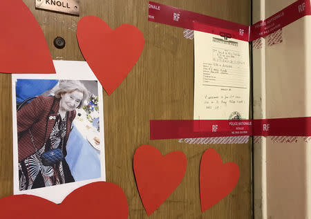 Red tape police seals and a photograph are seen on the front door of the appartment of Mireille Knoll in Paris, France, March 27, 2018. Mireille Knoll, 85, was found dead on Friday at her apartment in Paris's central 11th district. She had been stabbed multiple times and her flat set alight. REUTERS/Clotaire Achi