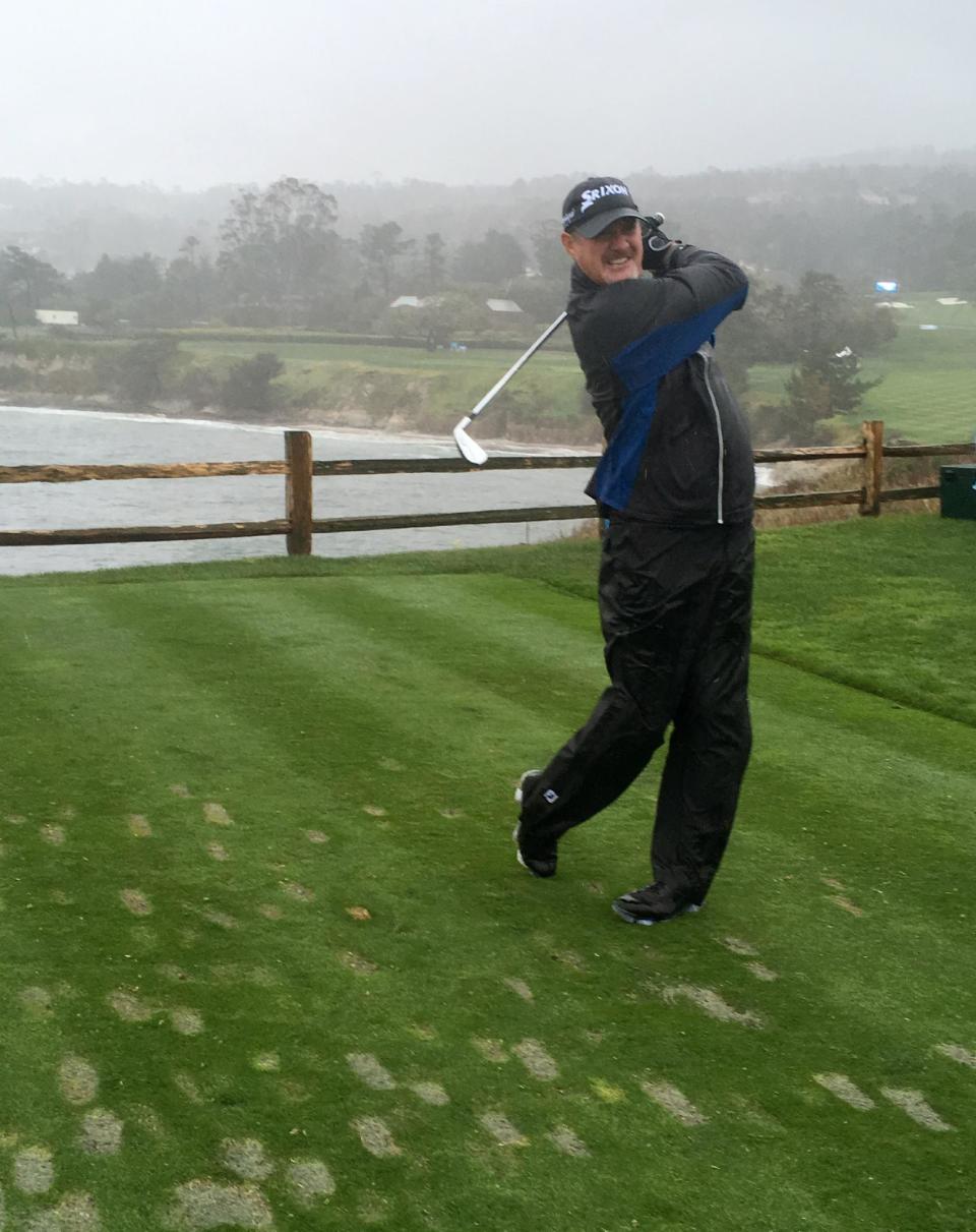PGA Tour veteran Jerry Kelly tees off with a 4-iron into the wind on the 106-yard seventh hole at Pebble beach, Calif., on Tuesday, Feb. 7, 2017. Even in conditions so bad Tuesday that the course was closed to spectators, Kelly couldn't wait to play with Green Bay quarterback Aaron Rodgers and two friends. (AP Photo/Doug Ferguson)