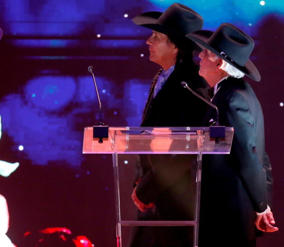 Rudy Ramos, right, and Mo Brings Plenty watch a presentation during the Western Heritage Awards at the National Cowboy & Western Heritage Museum in Oklahoma City, Saturday, April, 9, 2022.  