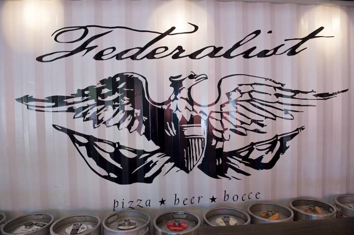 The Federalist logo is painted on the interior wall of shipping container at the Federalist Public House Wednesday June 3, 2015 in Sacramento. The Federalist Public House is a beer spot and pizza restaurant built from recycled shipping containers.