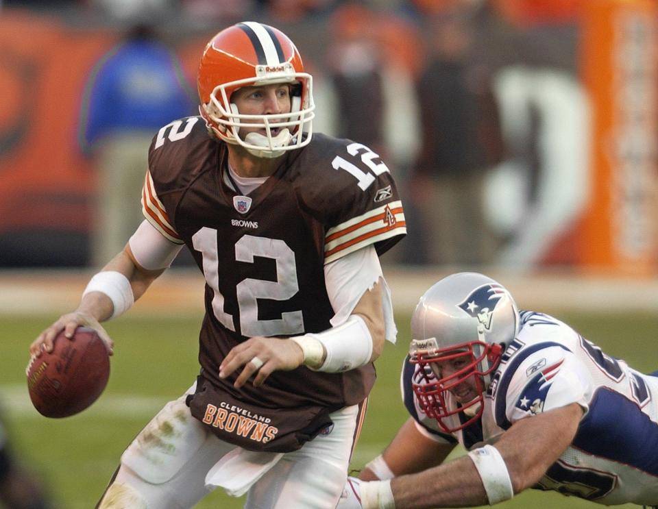 Cleveland Browns rookie quarterback Luke McCown (12) scrambles away from New England Patriots linebacker Mike Vrabel in the fourth quarter of the Browns' 42-15 loss Dec. 5, 2004, in Cleveland.