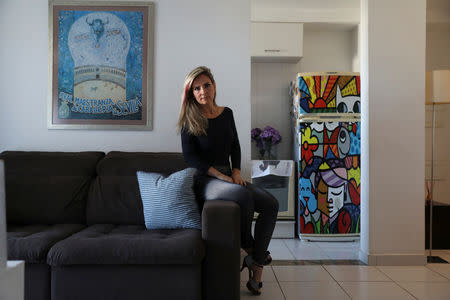 Community health nurse Larissa Lombardi, 46, supporter of Brazil's presidential candidate Jair Bolsonaro, poses for a portrait at her home in Rio de Janeiro, Brazil, October 22, 2018. REUTERS/Pilar Olivares