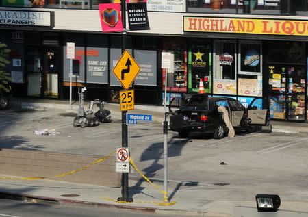 A bomb disposal robot is seen investigating a suspicious item in a vehicle near the Dolby Theater ahead of the 87th Academy Awards in Hollywood, California February 19, 2015. REUTERS/Robert Galbraith