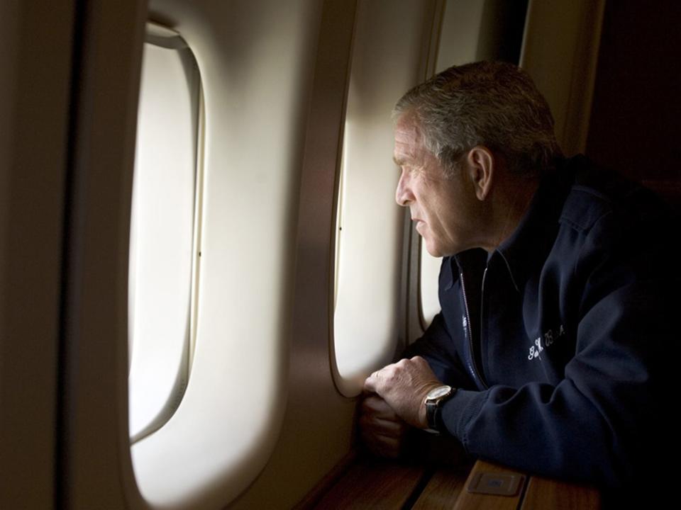 UNSPECIFIED - AUGUST 31: In this handout photo provided by the White House, U.S. President George W. Bush looks out over devastation from Hurricane Katrina as he heads back to Washington D.C. August 31, 2005 aboard Air Force One. Bush cut short his vacation and returned to Washington to monitor relief efforts for Hurricane Katrina.