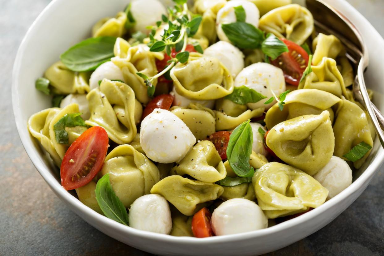 Italian pasta salad with spinach ricotta tortellini, mozzarella, tomatoes and basil