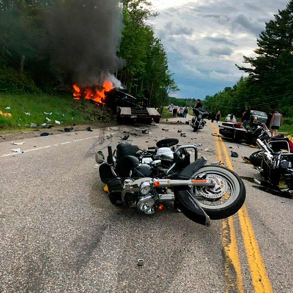 This photo provided by Miranda Thompson shows the scene where motorcycles and a pickup truck collided on a rural, two-lane highway Friday, June 21, 2019, in Randolph, N.H.