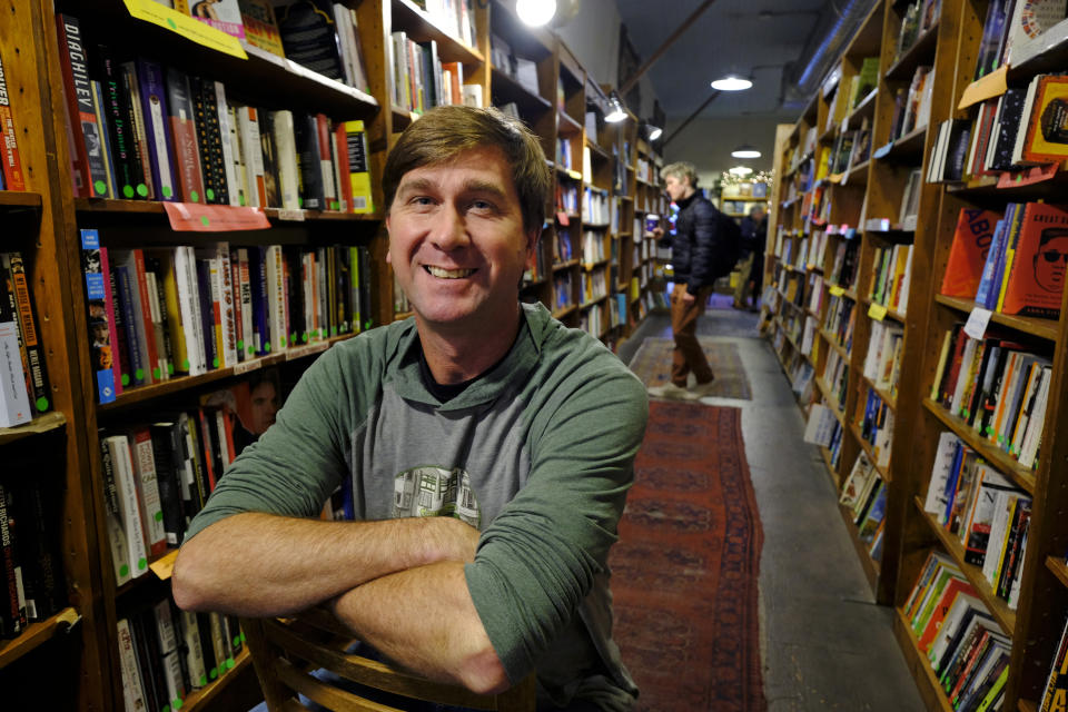 In this Wednesday, Dec. 4, 2019, photo Pete Mulvihill poses for a photo in his Browser Books store that he recently opened in San Francisco. Mulvihill has felt optimistic enough about being an independent bookseller that he bought a third store within the past two months. (AP Photo/Eric Risberg)