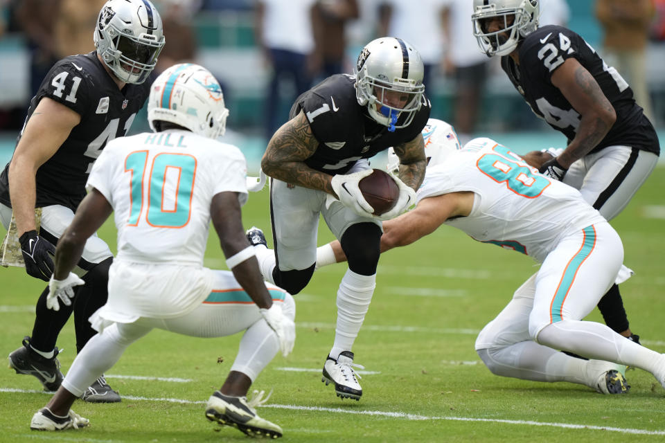 Las Vegas Raiders safety Marcus Epps (1) runs with the ball after he recovered it following a fumble by Miami Dolphins quarterback Tua Tagovailoa during the first half of an NFL football game, Sunday, Nov. 19, 2023, in Miami Gardens, Fla. (AP Photo/Wilfredo Lee)